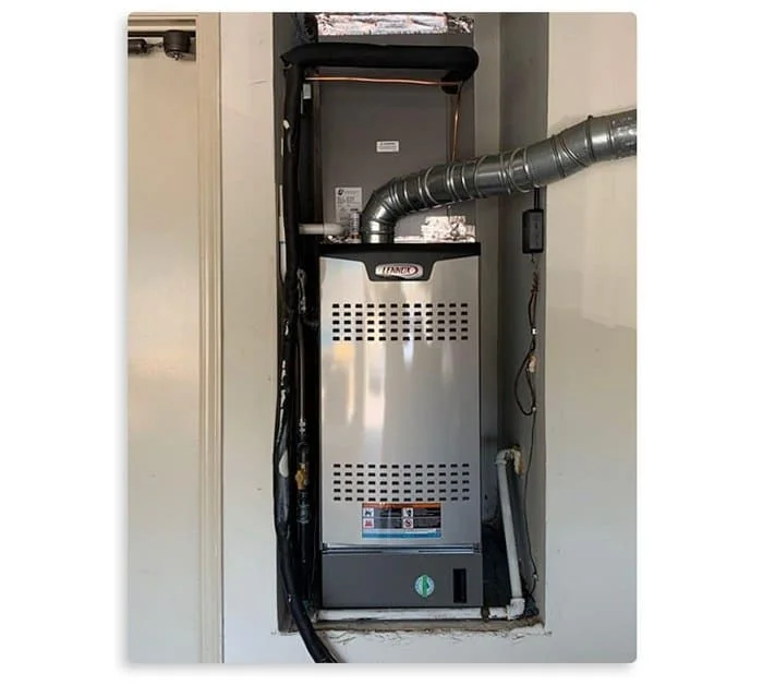A modern, silver Lennox furnace and air handler unit is professionally installed 